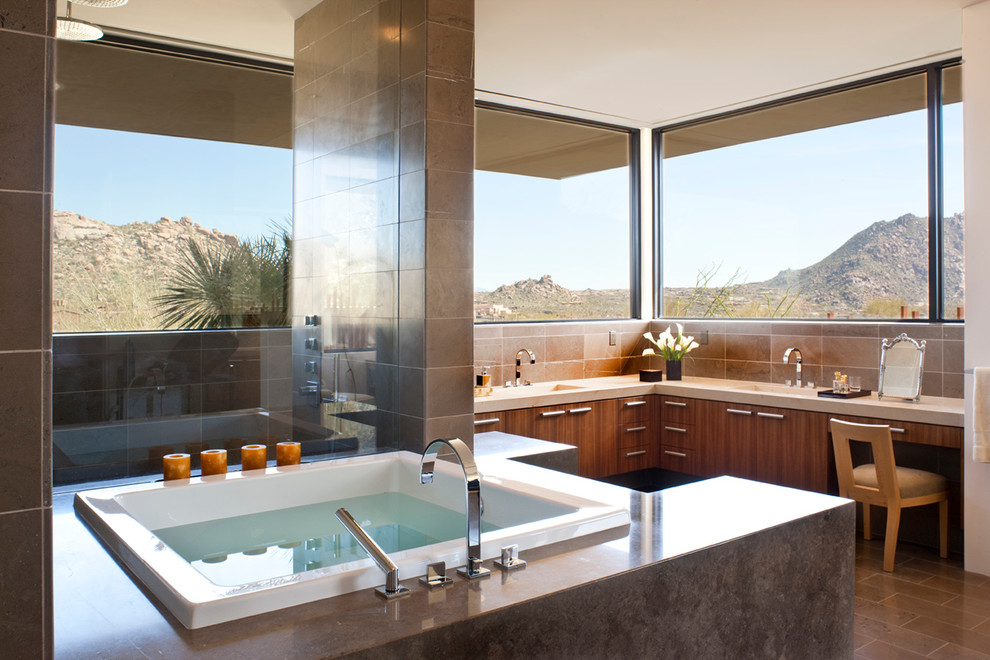 Inspiration for a huge modern master brown tile and stone tile gray floor bathroom remodel in Phoenix with an integrated sink, flat-panel cabinets, medium tone wood cabinets, limestone countertops and white walls