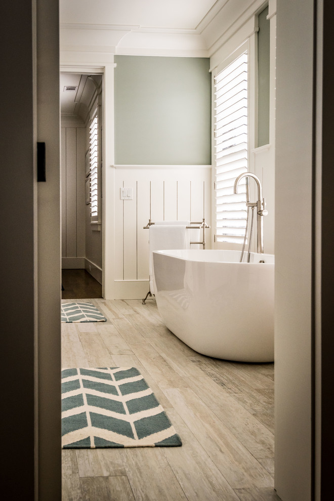Example of a large transitional 3/4 beige tile, white tile and porcelain tile porcelain tile and beige floor bathroom design in Charleston with shaker cabinets, white cabinets, green walls, an undermount sink, limestone countertops and a two-piece toilet