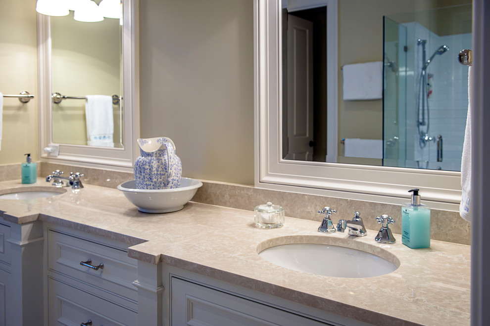 Esempio di una stanza da bagno tradizionale con lavabo sottopiano, top in marmo, piastrelle beige, pareti beige e pavimento in marmo