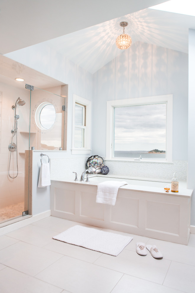 Design ideas for a large beach style ensuite bathroom in Boston with shaker cabinets, white cabinets, a built-in bath, a built-in shower, a two-piece toilet, white tiles, ceramic tiles, blue walls, porcelain flooring, a submerged sink, engineered stone worktops, grey floors, a hinged door, white worktops, a wall niche, double sinks and a built in vanity unit.