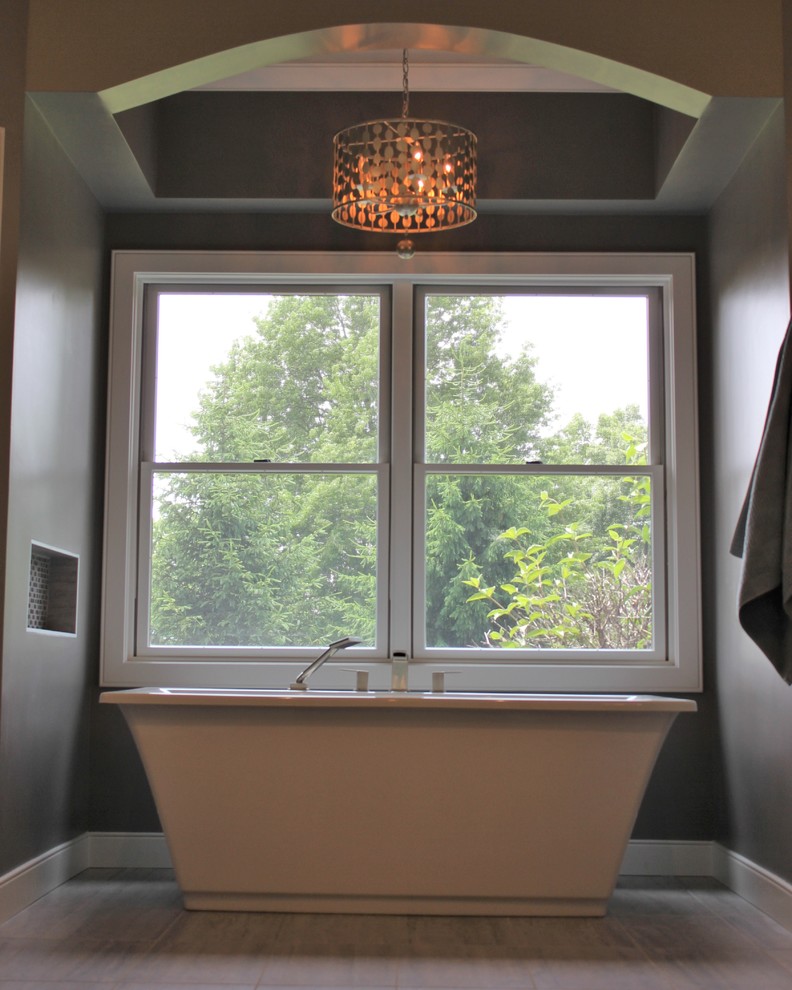 This is an example of a large traditional ensuite bathroom in Chicago with a submerged sink, freestanding cabinets, dark wood cabinets, engineered stone worktops, a freestanding bath, a corner shower, grey tiles, grey walls and ceramic flooring.