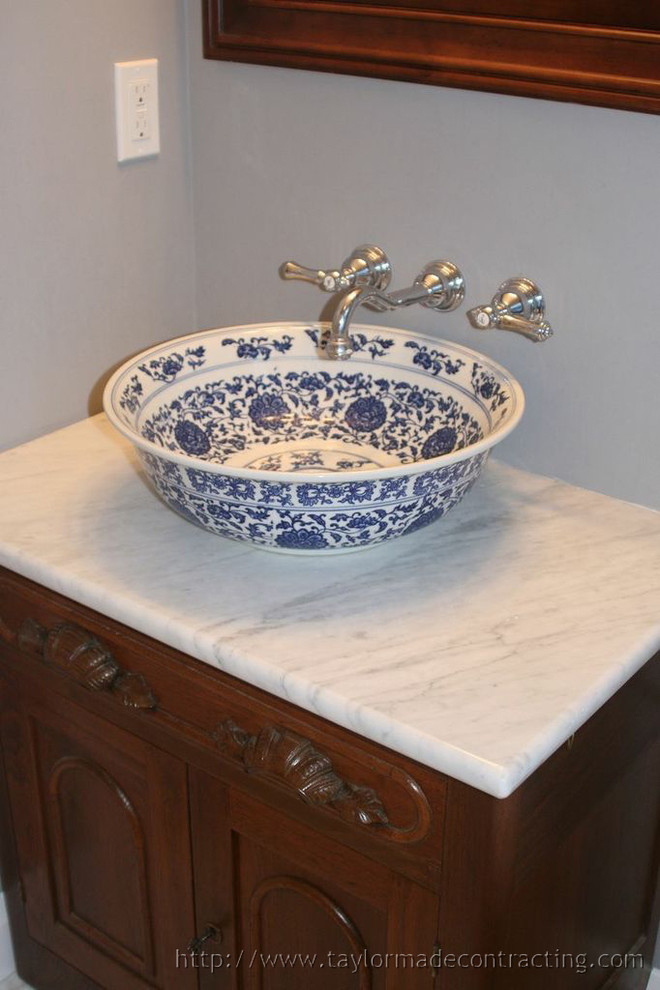 Example of a small classic gray tile and ceramic tile ceramic tile, gray floor and single-sink alcove bathtub design in Baltimore with dark wood cabinets, blue walls, a vessel sink, marble countertops, white countertops, a niche and a freestanding vanity