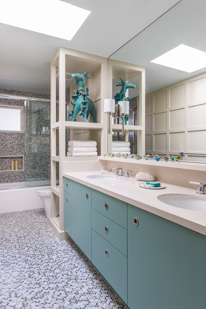 Photo of a large classic ensuite bathroom in San Francisco with flat-panel cabinets, blue cabinets, an alcove bath, an alcove shower, a two-piece toilet, multi-coloured tiles, ceramic tiles, beige walls, ceramic flooring, a built-in sink, solid surface worktops, multi-coloured floors and a sliding door.