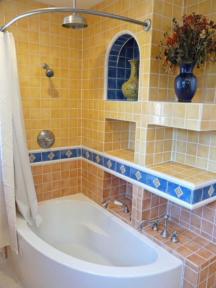 Example of a mid-sized southwest master yellow tile and ceramic tile ceramic tile bathroom design in San Diego with furniture-like cabinets, an undermount sink, tile countertops, dark wood cabinets, a one-piece toilet and gray walls