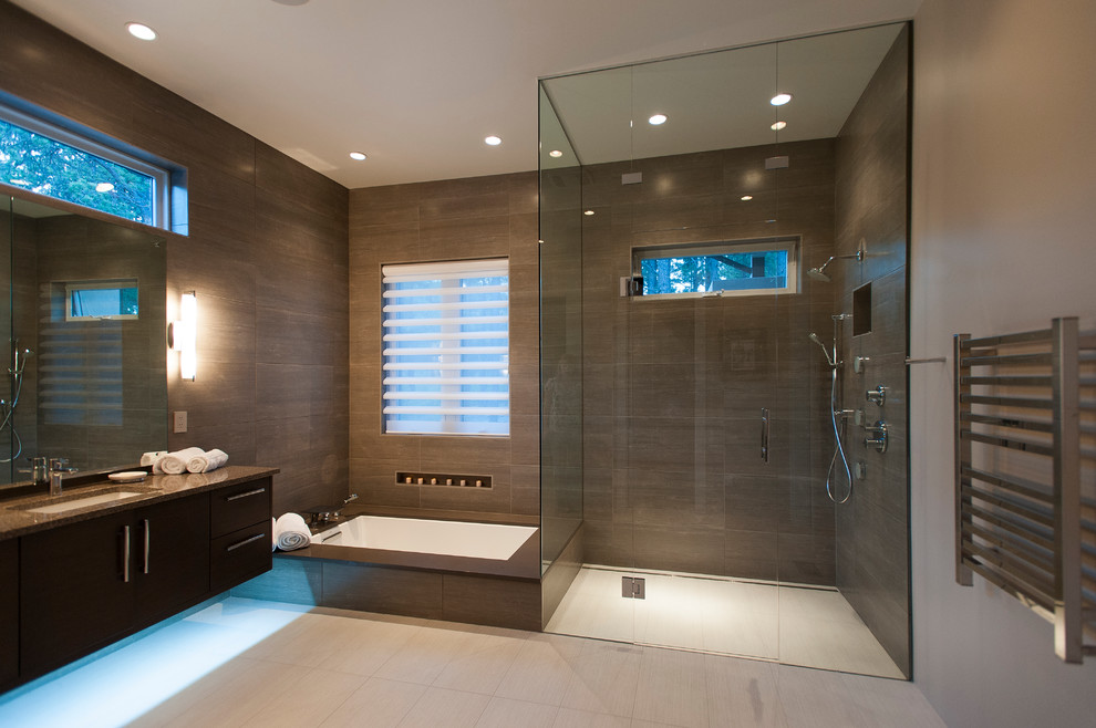 Large contemporary ensuite bathroom in Denver with a submerged sink, flat-panel cabinets, dark wood cabinets, engineered stone worktops, a submerged bath, a built-in shower, grey tiles, porcelain tiles, porcelain flooring, grey walls, beige floors and a hinged door.