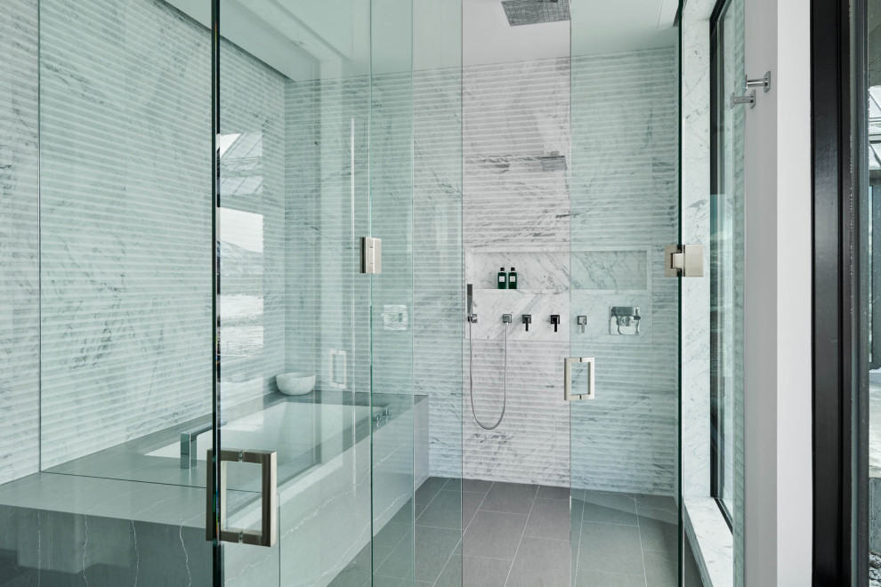 Trendy white tile gray floor wet room photo in Denver with an undermount tub, a hinged shower door and a niche