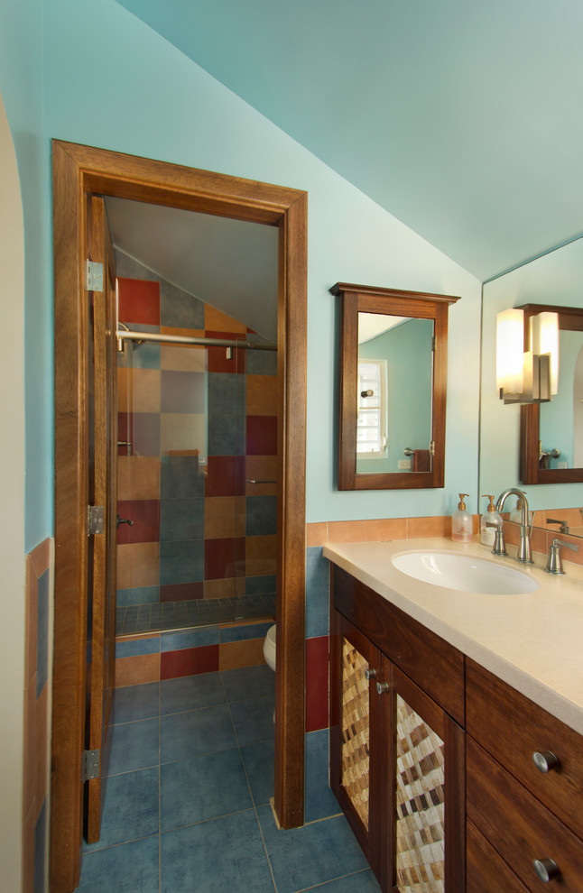 Inspiration for a tropical multicolored tile ceramic tile bathroom remodel in DC Metro with recessed-panel cabinets, medium tone wood cabinets and blue walls