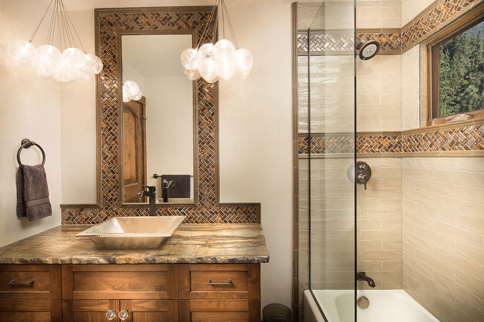 Eclectic bathroom in Other with shaker cabinets, medium wood cabinets, a built-in bath, a shower/bath combination, brown tiles, porcelain tiles, beige walls, slate flooring, a vessel sink and marble worktops.