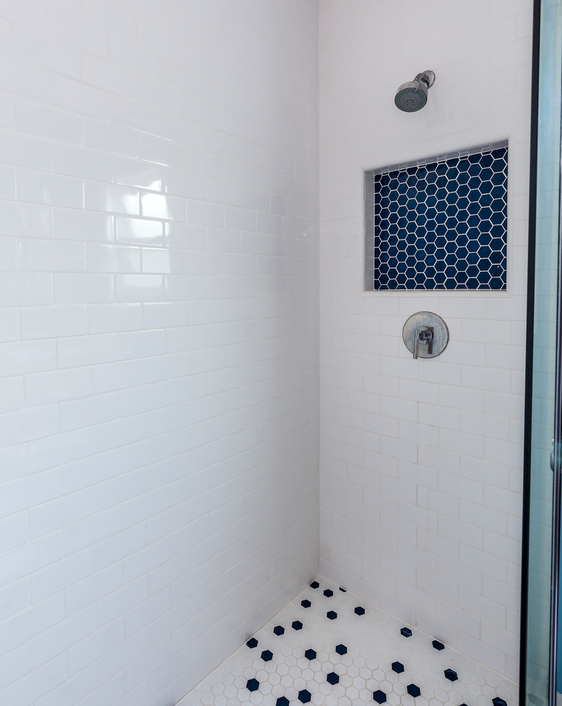 This is an example of a medium sized contemporary ensuite bathroom in Los Angeles with flat-panel cabinets, light wood cabinets, an alcove shower, a two-piece toilet, blue tiles, blue walls, a submerged sink, engineered stone worktops, white floors, a sliding door, metro tiles and porcelain flooring.