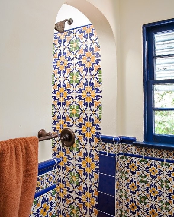 Example of a mid-sized eclectic master blue tile and ceramic tile terra-cotta tile alcove shower design in San Diego with a drop-in sink, raised-panel cabinets, dark wood cabinets, wood countertops, a two-piece toilet and beige walls