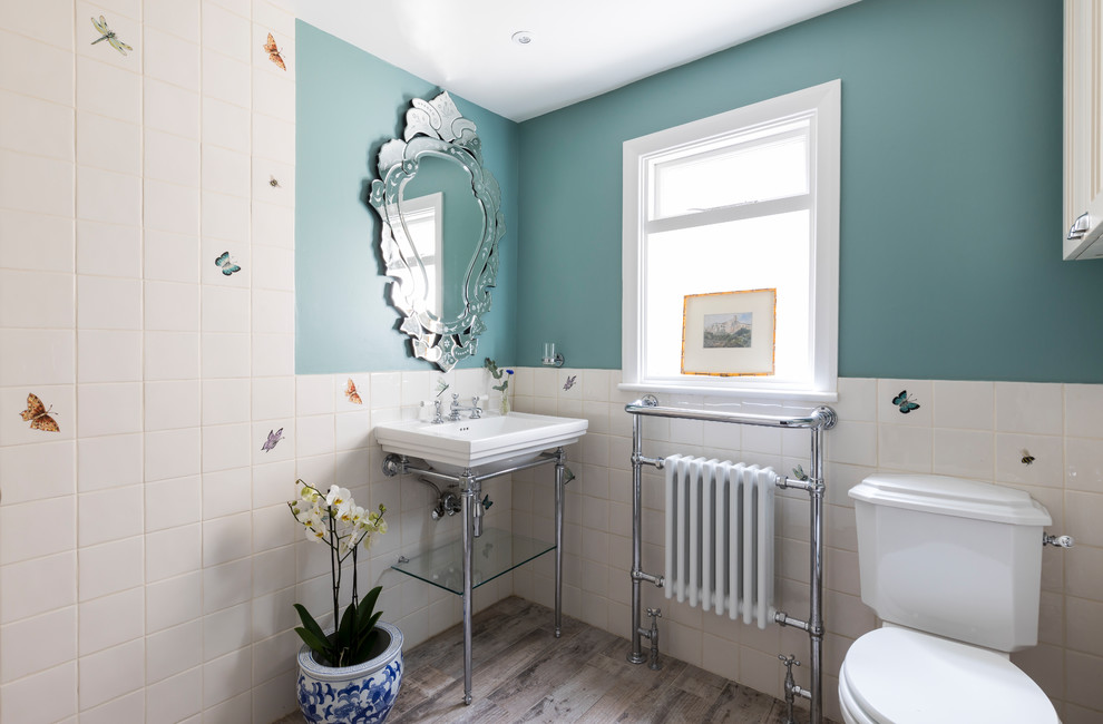 Inspiration for a mid-sized farmhouse gray floor bathroom remodel in London with blue cabinets, a one-piece toilet and blue walls