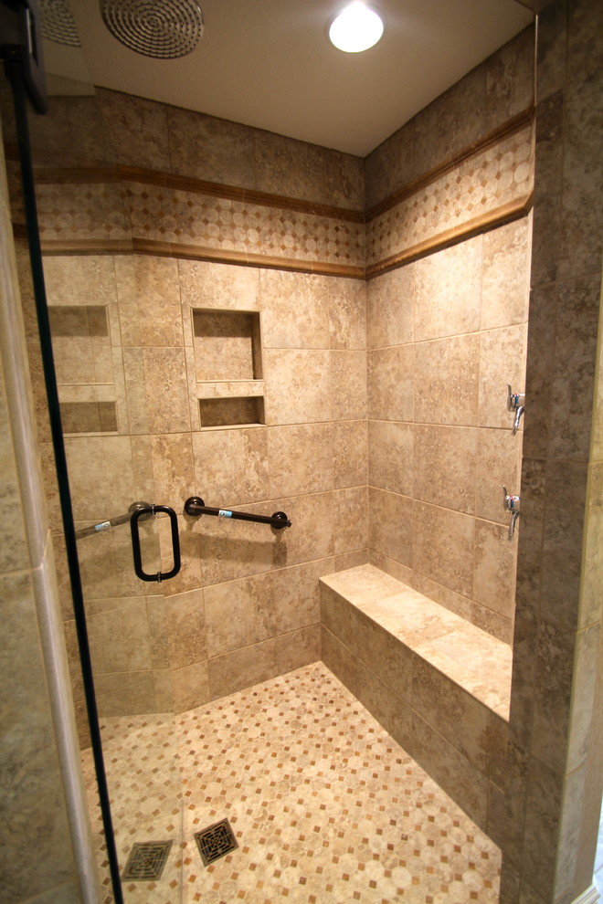 Walk-in shower - craftsman master beige tile and ceramic tile ceramic tile walk-in shower idea in Other with shaker cabinets, medium tone wood cabinets, granite countertops and gray walls