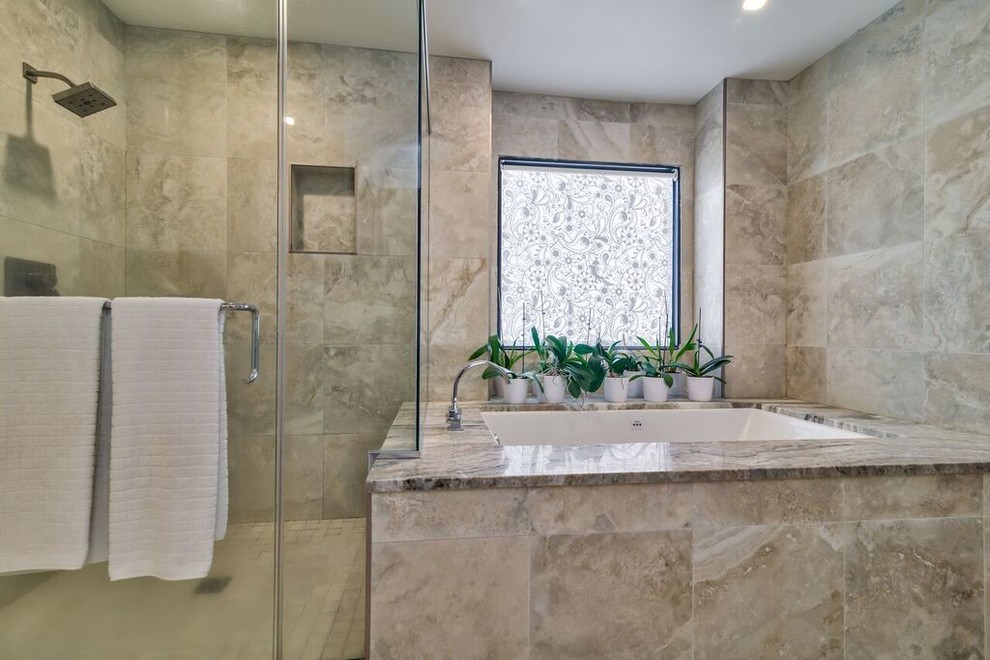 Cette image montre une grande salle de bain principale design avec une baignoire encastrée, une douche d'angle, un mur gris et une cabine de douche à porte battante.