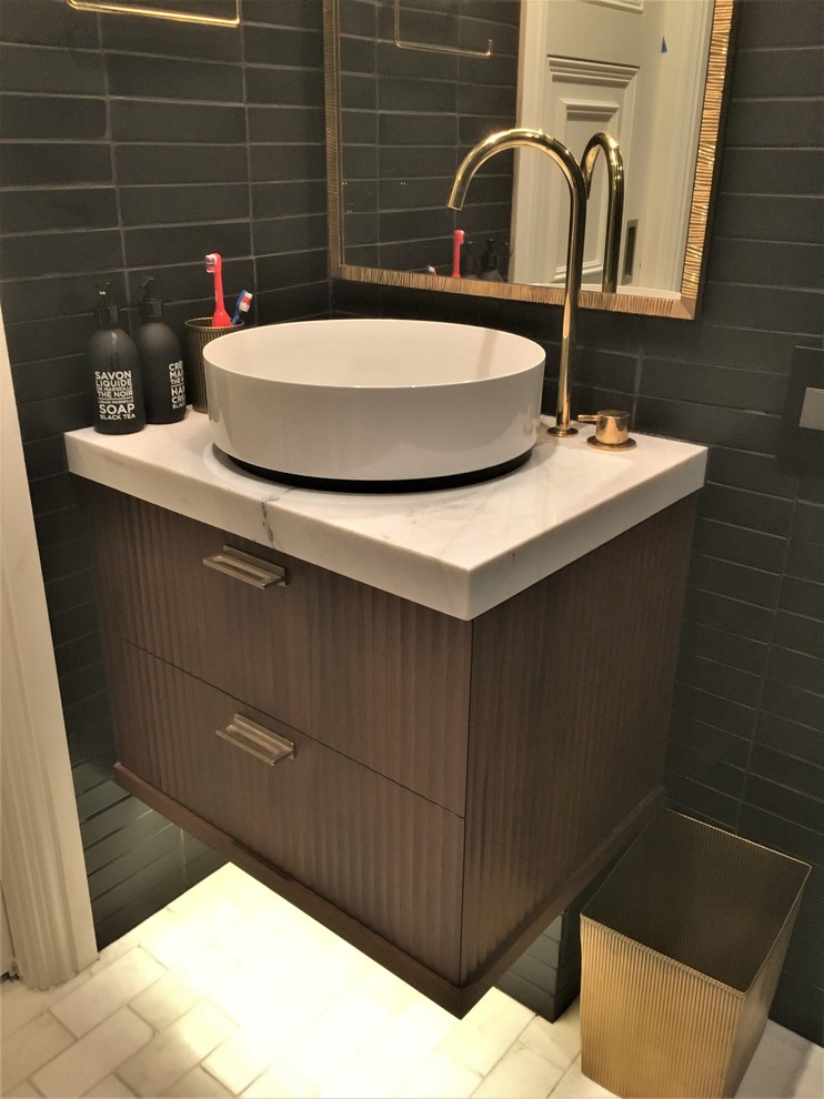 Example of a small minimalist 3/4 black tile marble floor and white floor walk-in shower design in Other with flat-panel cabinets, dark wood cabinets, black walls, a vessel sink, marble countertops and a hinged shower door