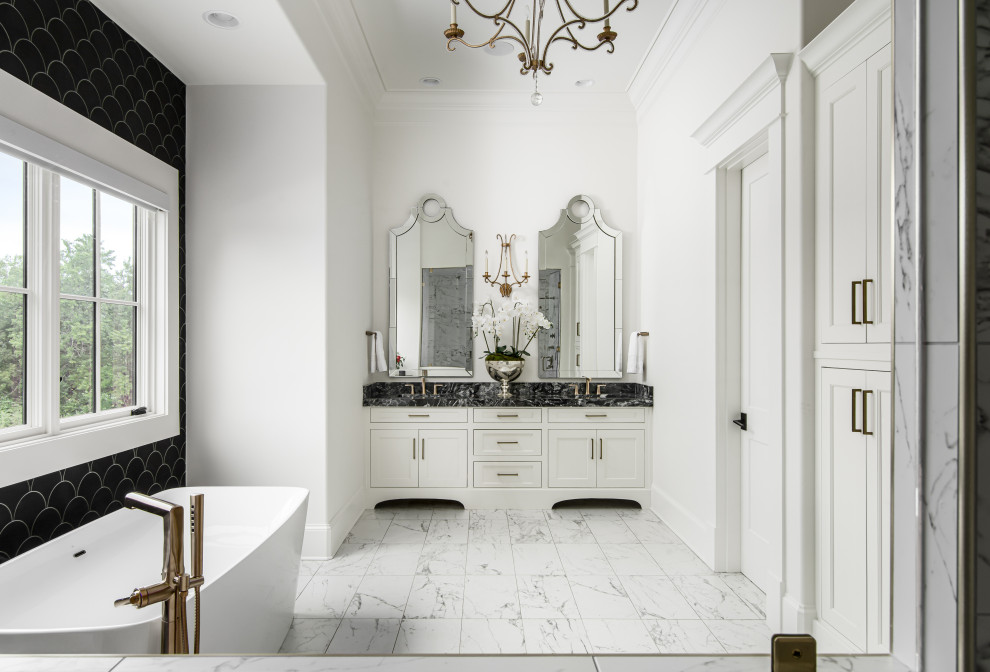 Design ideas for a large traditional ensuite bathroom in Nashville with white cabinets, a freestanding bath, an alcove shower, black and white tiles, white walls, a submerged sink, white floors, a hinged door, black worktops, an enclosed toilet, double sinks and a built in vanity unit.