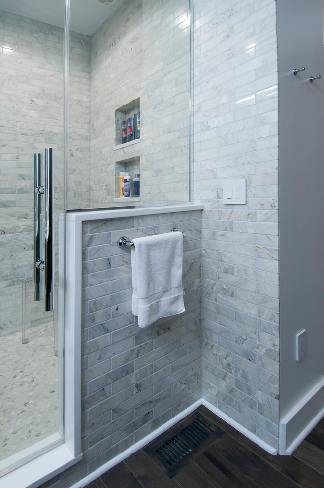 Photo of a medium sized modern bathroom in Columbus with flat-panel cabinets, medium wood cabinets, a double shower, a one-piece toilet, grey tiles, stone tiles, white walls, medium hardwood flooring, a vessel sink and solid surface worktops.