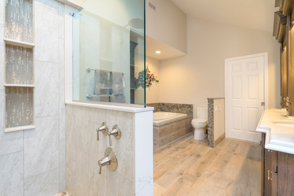 Example of a large classic master gray tile and stone slab porcelain tile and beige floor bathroom design in Philadelphia with flat-panel cabinets, medium tone wood cabinets, a two-piece toilet, beige walls, an undermount sink, quartz countertops and white countertops