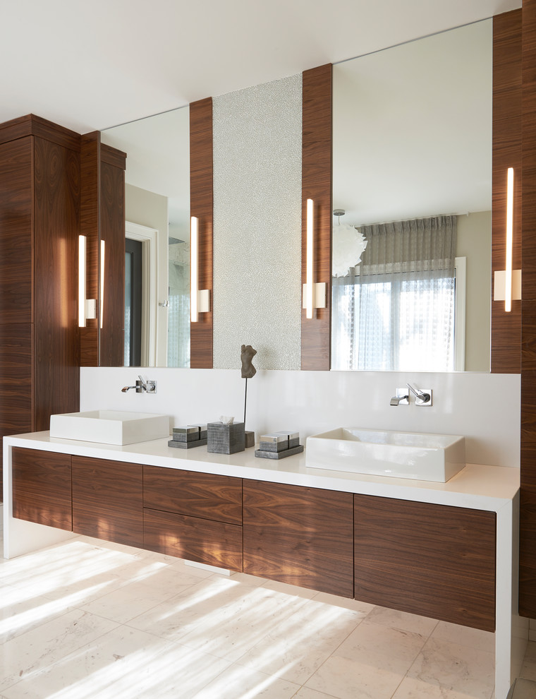 Inspiration for a large contemporary ensuite bathroom in Toronto with flat-panel cabinets, dark wood cabinets, brown walls, marble flooring, a vessel sink, engineered stone worktops, white floors, a freestanding bath, an alcove shower, white tiles, marble tiles and a hinged door.