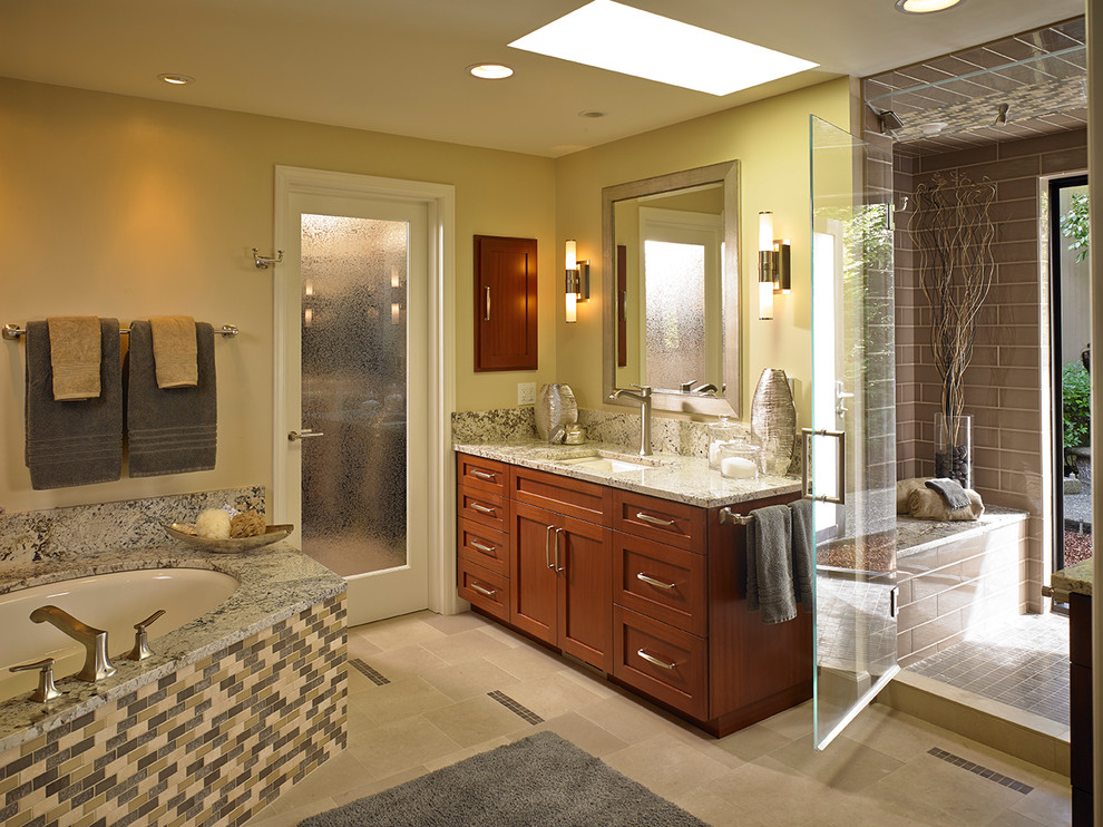 Bathroom - large contemporary master beige tile and stone slab porcelain tile and beige floor bathroom idea in Seattle with an undermount sink, shaker cabinets, medium tone wood cabinets, granite countertops, a one-piece toilet, yellow walls and a hinged shower door