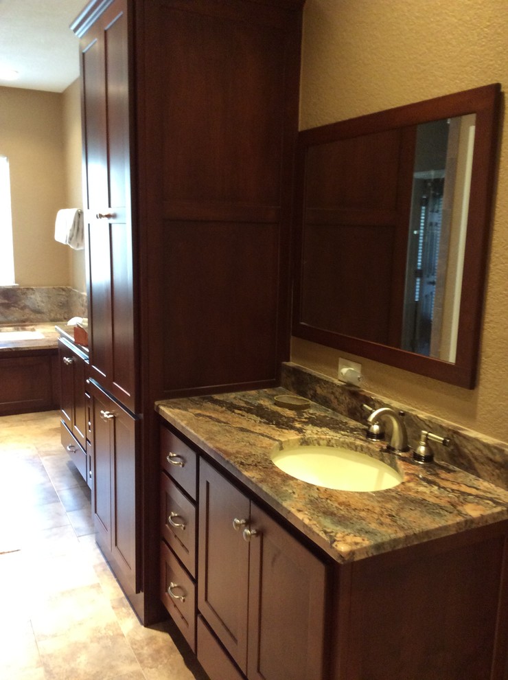Example of a mid-sized transitional master linoleum floor bathroom design in Austin with recessed-panel cabinets, dark wood cabinets, beige walls, an undermount sink and granite countertops