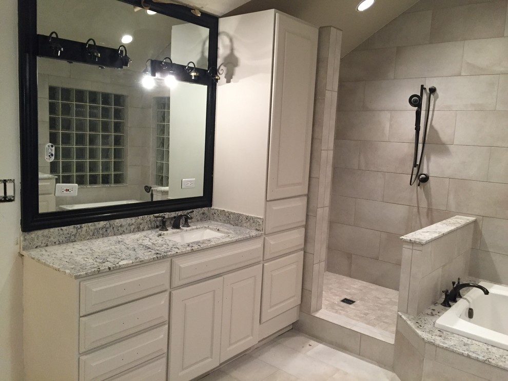 Medium sized classic ensuite bathroom in Houston with beaded cabinets, beige cabinets, a built-in bath, a walk-in shower, beige tiles, porcelain tiles, beige walls, porcelain flooring, a submerged sink and granite worktops.