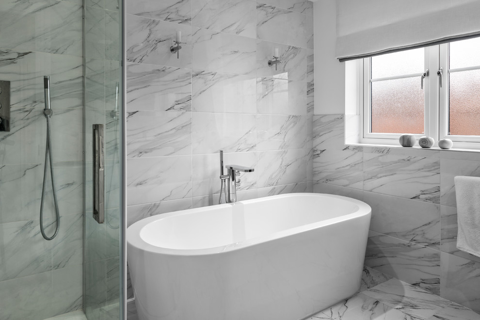 Inspiration for a medium sized contemporary bathroom in Berkshire with a freestanding bath, a corner shower, a one-piece toilet, grey tiles, porcelain tiles, white walls, porcelain flooring and an integrated sink.