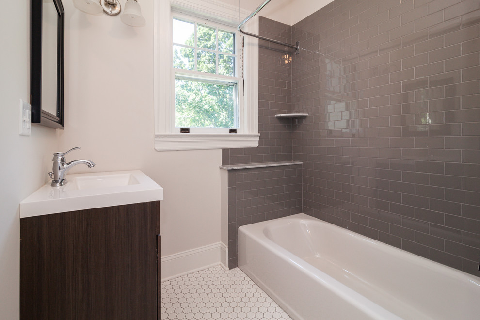 Design ideas for a medium sized victorian shower room bathroom in New York with shaker cabinets, dark wood cabinets, an alcove bath, a shower/bath combination, grey tiles, ceramic tiles, beige walls, porcelain flooring, an integrated sink, engineered stone worktops, white floors and a shower curtain.