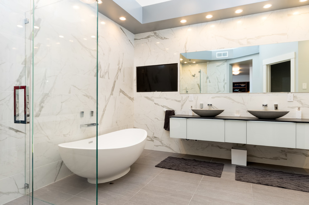 Minimalist master stone slab porcelain tile and beige floor bathroom photo in San Francisco with flat-panel cabinets, white cabinets, white walls, a vessel sink and a hinged shower door