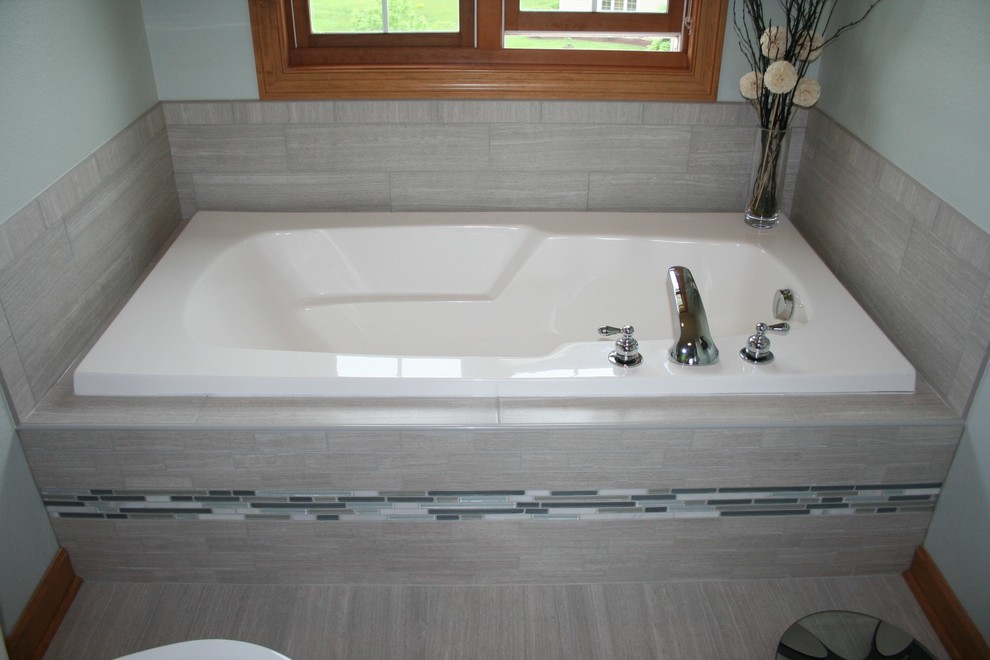 Example of a large minimalist master gray tile and porcelain tile porcelain tile bathroom design in Milwaukee with a drop-in sink, recessed-panel cabinets, medium tone wood cabinets, laminate countertops, a two-piece toilet and green walls
