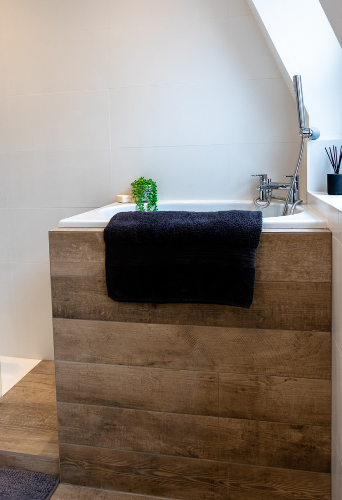 Bathroom - mid-sized contemporary kids' white tile and ceramic tile cement tile floor and brown floor bathroom idea in London with white cabinets, a one-piece toilet, white walls, granite countertops, a hinged shower door and black countertops