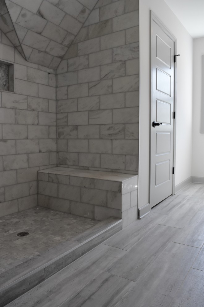 Mid-sized transitional gray tile and subway tile light wood floor alcove shower photo in Atlanta with white walls