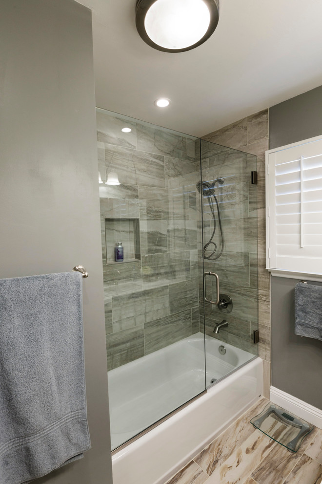 Inspiration for a small transitional 3/4 multicolored tile and porcelain tile porcelain tile bathroom remodel in Los Angeles with an undermount sink, recessed-panel cabinets, white cabinets, quartz countertops, a one-piece toilet and gray walls