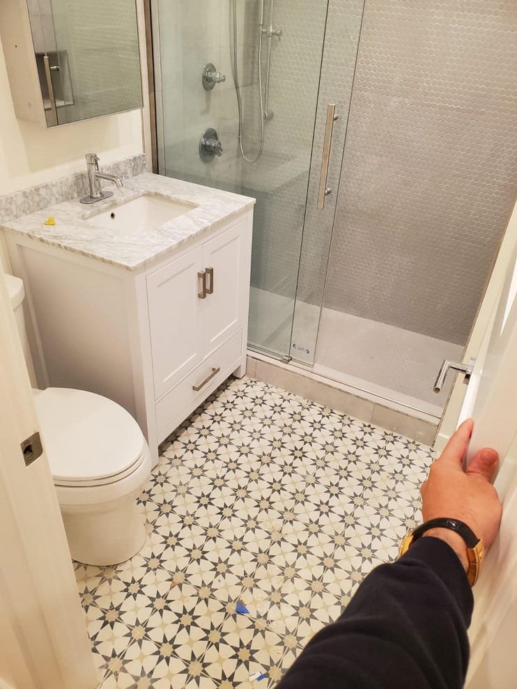 Inspiration for a small modern master gray tile and porcelain tile ceramic tile and multicolored floor bathroom remodel in San Francisco with flat-panel cabinets, white cabinets, a two-piece toilet, white walls, an undermount sink, quartz countertops and multicolored countertops