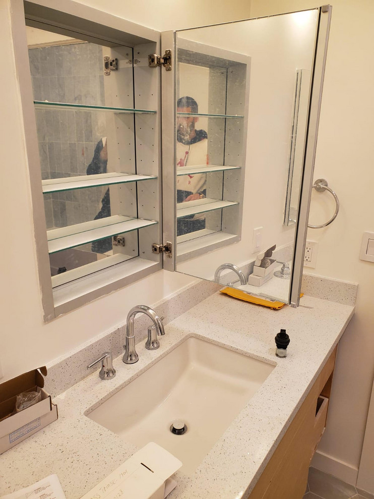 Idéer för små funkis flerfärgat en-suite badrum, med släta luckor, vita skåp, ett platsbyggt badkar, en dusch/badkar-kombination, en toalettstol med separat cisternkåpa, grå kakel, porslinskakel, vita väggar, klinkergolv i keramik, ett undermonterad handfat, bänkskiva i kvarts, flerfärgat golv och dusch med duschdraperi