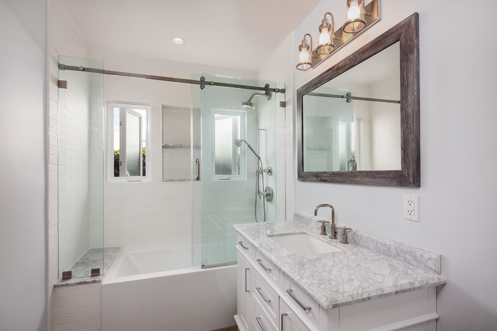 Small transitional kids' white tile and porcelain tile porcelain tile and brown floor bathroom photo in Los Angeles with furniture-like cabinets, a one-piece toilet, gray walls, an undermount sink, marble countertops, white cabinets and gray countertops