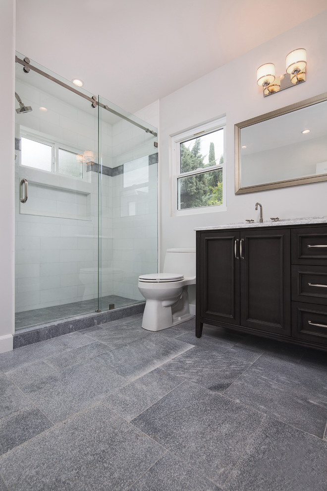 Example of a mid-sized transitional 3/4 white tile and marble tile marble floor and gray floor bathroom design in Los Angeles with furniture-like cabinets, black cabinets, a one-piece toilet, gray walls, an undermount sink, marble countertops and white countertops