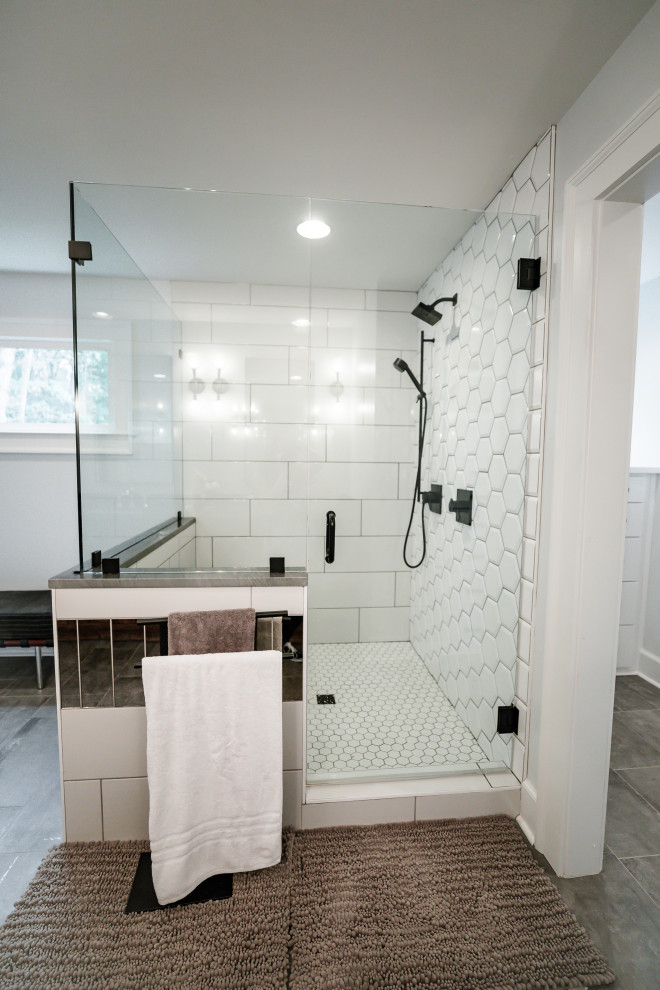Mid-sized cottage chic master white tile and porcelain tile porcelain tile and gray floor double shower photo in Atlanta with furniture-like cabinets, dark wood cabinets, white walls, an undermount sink, quartzite countertops, a hinged shower door and gray countertops