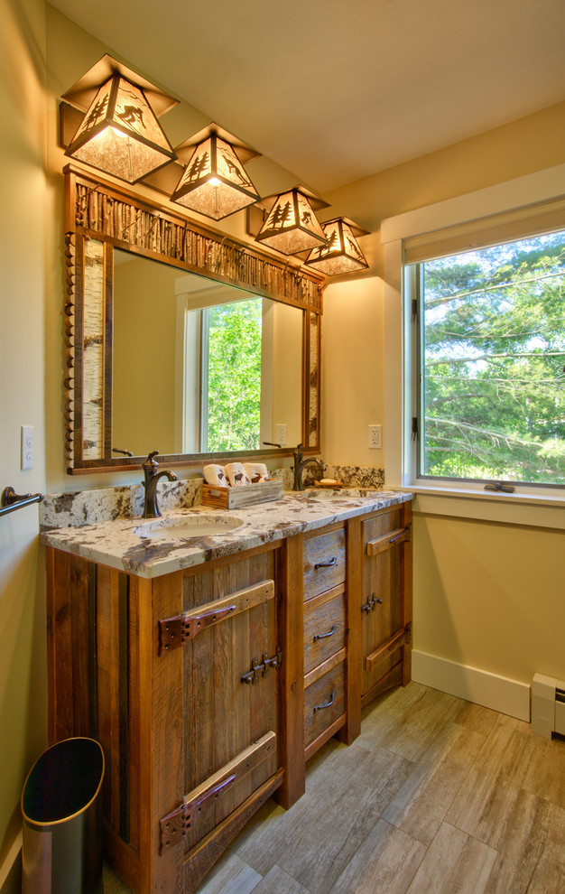 Example of a small mountain style kids' porcelain tile porcelain tile and double-sink corner shower design in Manchester with furniture-like cabinets, a two-piece toilet, an undermount sink, granite countertops, brown cabinets and a built-in vanity