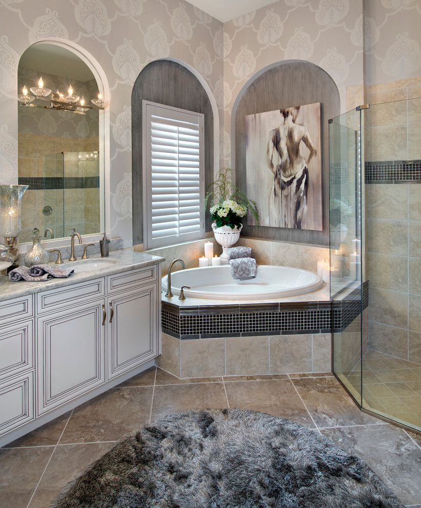 Photo of a large classic ensuite bathroom in Miami with raised-panel cabinets, white cabinets, a corner bath, a corner shower, porcelain flooring, a submerged sink, engineered stone worktops, beige floors and a hinged door.