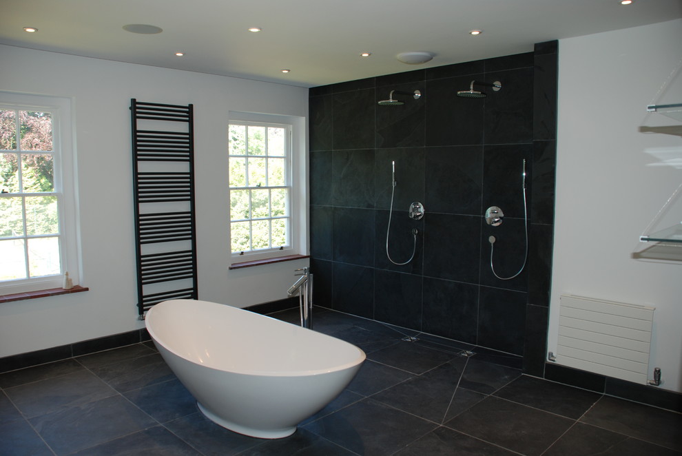 Large trendy black tile and stone tile slate floor bathroom photo in Hampshire with a wall-mount sink and a wall-mount toilet
