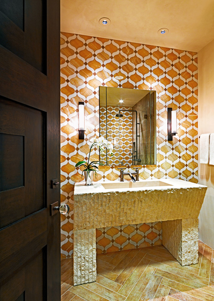 На фото: ванная комната в современном стиле с монолитной раковиной, оранжевой плиткой и оранжевыми стенами с