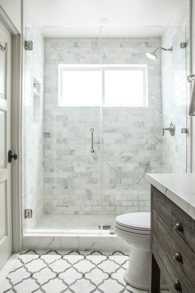 Example of a mid-sized transitional white tile and stone tile marble floor alcove shower design in Los Angeles with flat-panel cabinets, medium tone wood cabinets, a two-piece toilet, white walls, an undermount sink and marble countertops