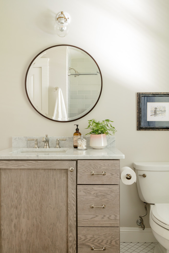 Ceramic tile and white floor bathroom photo in Boston with flat-panel cabinets, light wood cabinets, a one-piece toilet, gray walls, an undermount sink and marble countertops