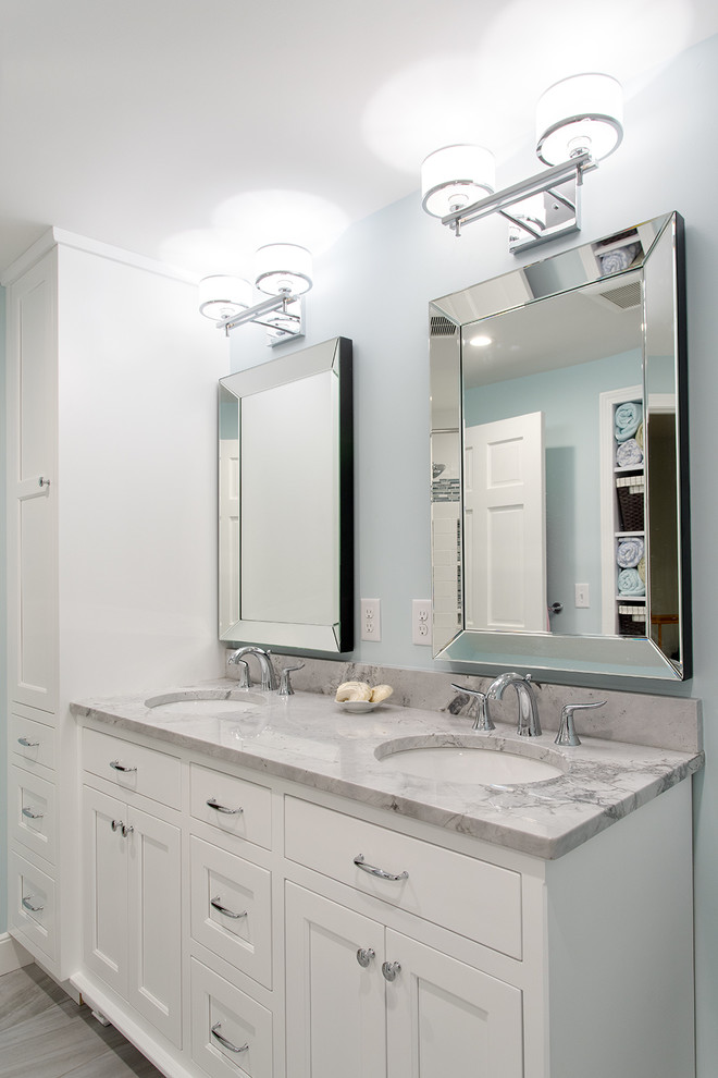 Large trendy kids' white tile and stone slab porcelain tile bathroom photo in Boston with white cabinets, a two-piece toilet, blue walls, an undermount sink, quartzite countertops and recessed-panel cabinets