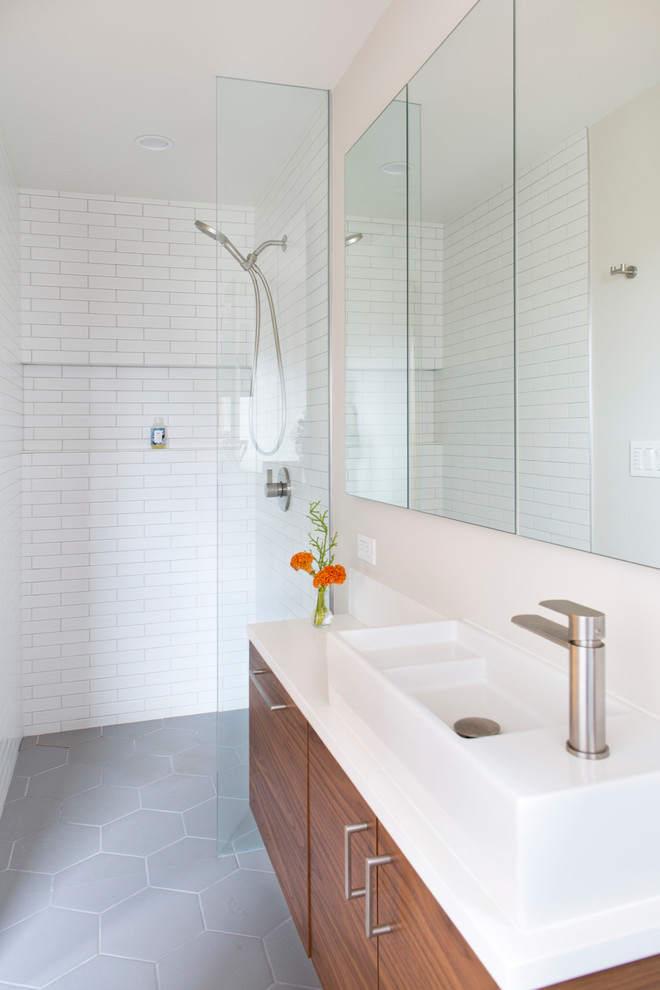 Photo of a small midcentury ensuite bathroom in Portland with flat-panel cabinets, medium wood cabinets, a built-in shower, a wall mounted toilet, white tiles, ceramic tiles, white walls, medium hardwood flooring, a vessel sink, engineered stone worktops and an open shower.