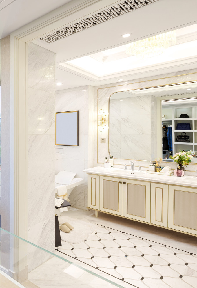 Inspiration for a medium sized contemporary ensuite bathroom in Los Angeles with recessed-panel cabinets, white cabinets, a freestanding bath, a corner shower, white tiles, marble tiles, white walls, marble flooring, an integrated sink, marble worktops, white floors, a hinged door and white worktops.