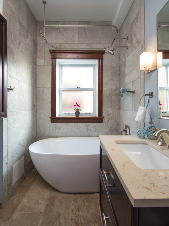 Photo of a medium sized contemporary ensuite bathroom in Chicago with recessed-panel cabinets, dark wood cabinets, a freestanding bath, a shower/bath combination, a two-piece toilet, white tiles, stone tiles, blue walls, slate flooring, a submerged sink and marble worktops.