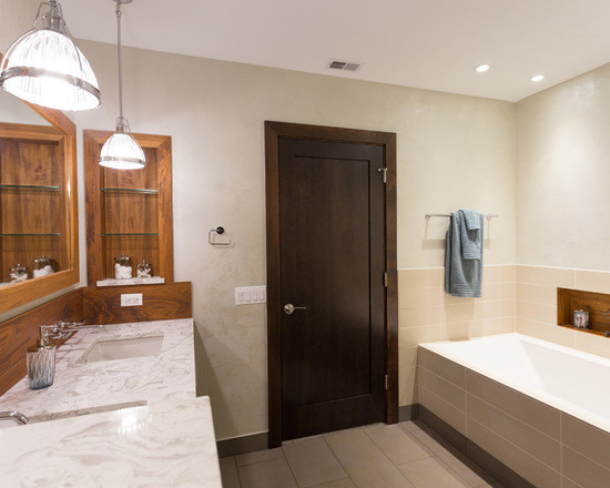 This is an example of a medium sized classic ensuite bathroom in Chicago with flat-panel cabinets, medium wood cabinets, an alcove bath, an alcove shower, a two-piece toilet, white tiles, ceramic tiles, white walls, ceramic flooring, a submerged sink and marble worktops.