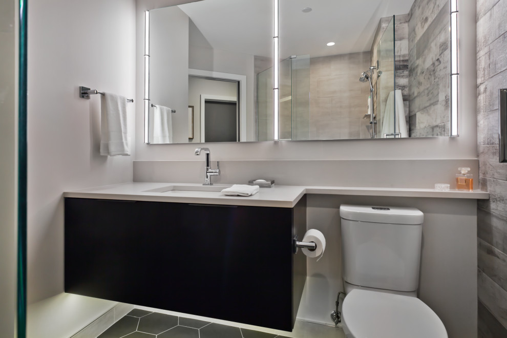 Design ideas for a small contemporary shower room bathroom in Minneapolis with flat-panel cabinets, black cabinets, a corner shower, a two-piece toilet, grey tiles, ceramic tiles, white walls, ceramic flooring, a submerged sink, solid surface worktops, grey floors, a hinged door and white worktops.