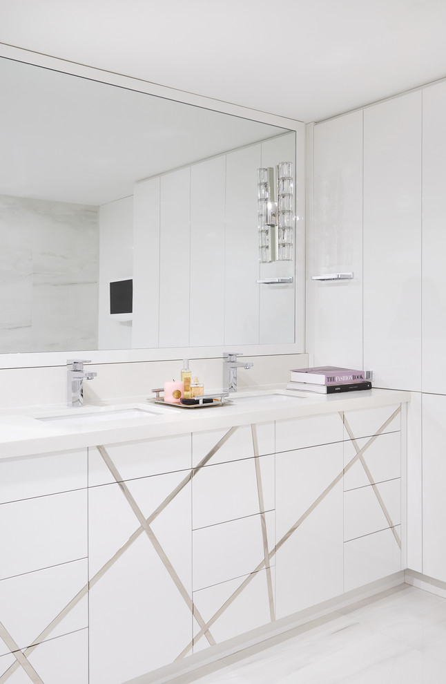 Inspiration for a mid-sized contemporary master white tile and marble tile white floor and porcelain tile bathroom remodel in Toronto with flat-panel cabinets, white cabinets, white walls, an undermount sink, white countertops and solid surface countertops